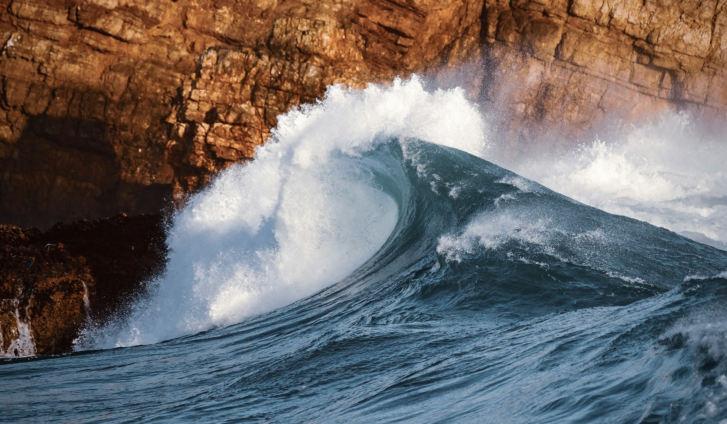Aerial view of a glassy ocean wave barrelling open